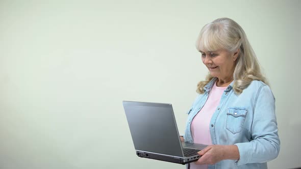 Elderly Lady Surprised With Message on Laptop