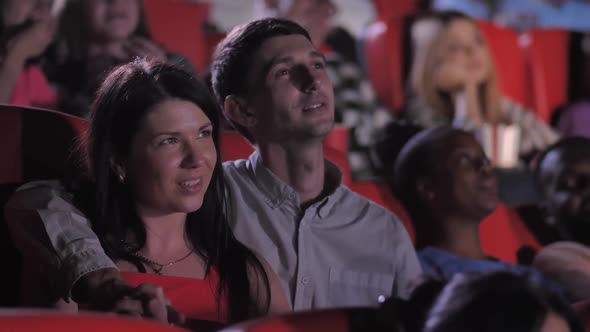 Loving Couple Watching Movie at Cinema Theater