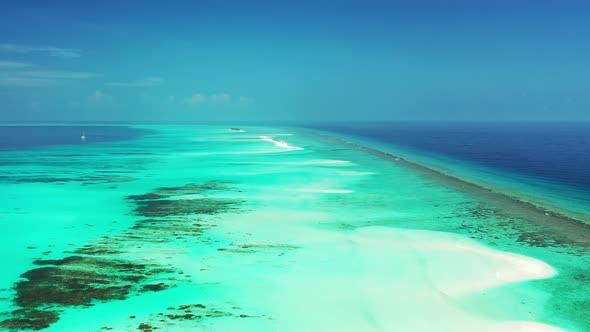 Wide angle drone clean view of a white sand paradise beach and turquoise sea background in hi res 4K