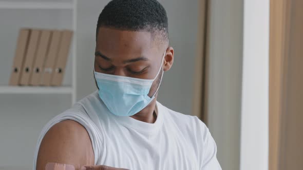 Moving Footage African Sick Man Patient Wears Face Protective Mask Points Finger at Medical Patch on