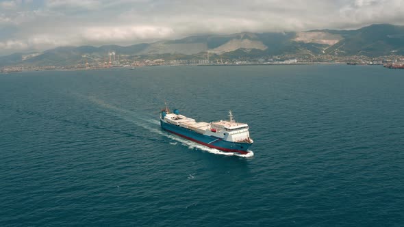 Aerial Panorama of Sailing Dry Cargo Ship and Coastal Landscapes