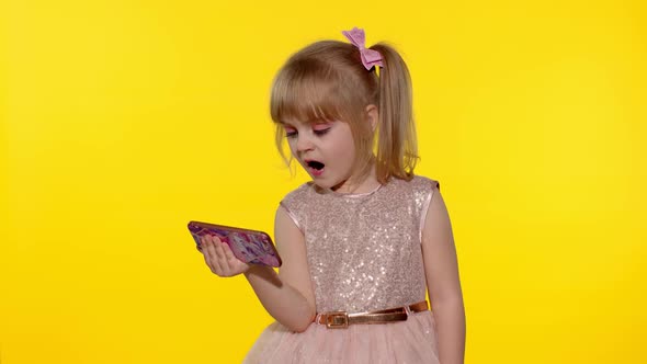 Child girl using smartphone, Kid looking at the screen of a mobile phone, watching cartoons