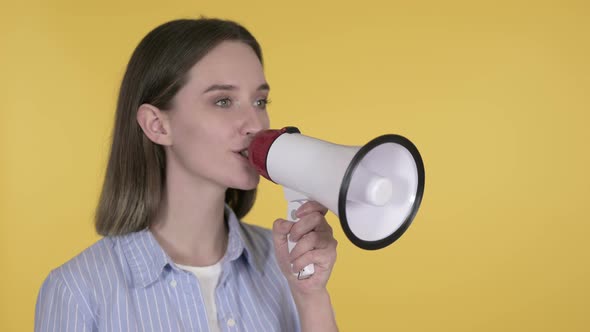 Announcing Young Woman Shouting Through Megaphone, Yellow Background