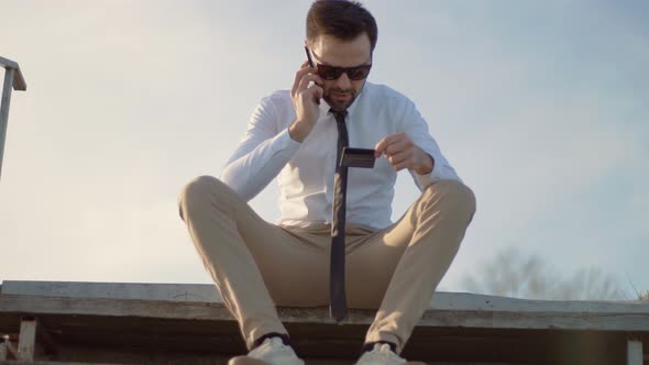 Businessman Making Online Payment Holding Bank Card. Man Checking Money Balance On Credit Card.