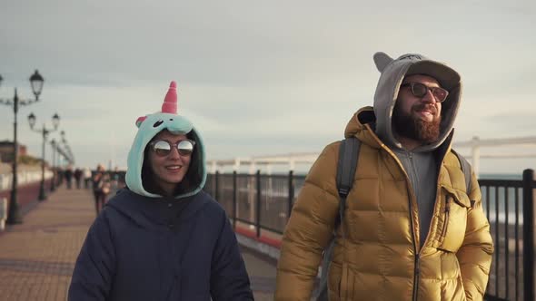 an Adult Man and His Girlfriend Are Walking Along the Street on a Sunny Day