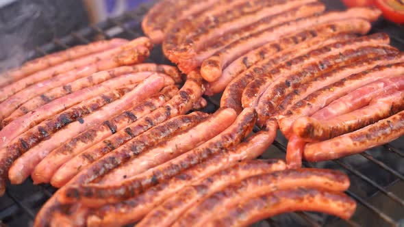 Tasty Sausages with the Addition Vegetables Sizzling on a Portable BBQ