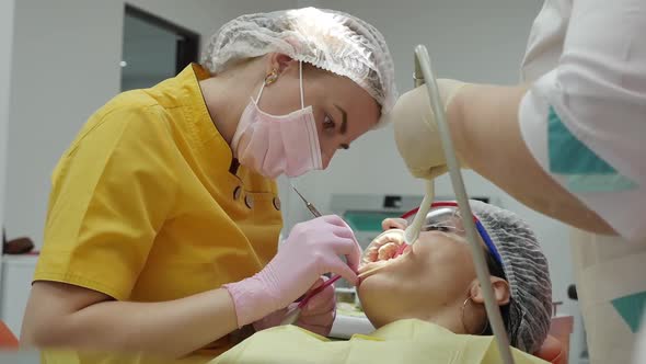 Close Up Female Hands Professional Doctor Stomatologist at Work. Person Undergoes a Medical