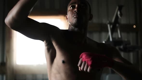 Boxer punching a punching bag in the gym