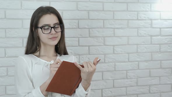 Smart student with a textbook. 