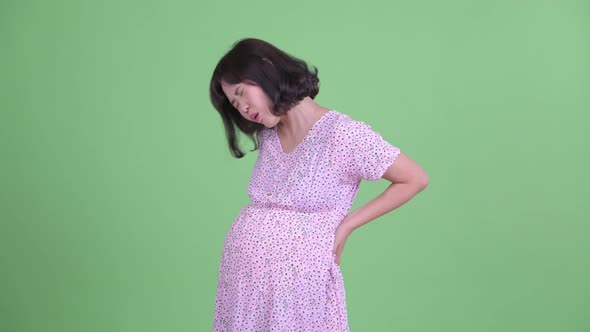 Stressed Asian Pregnant Woman Having Back Pain