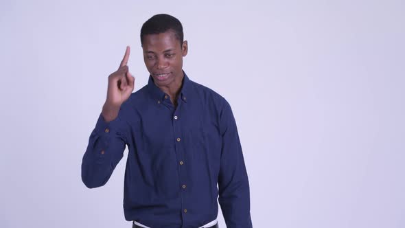 Young Serious African Businessman Talking and Pointing Finger