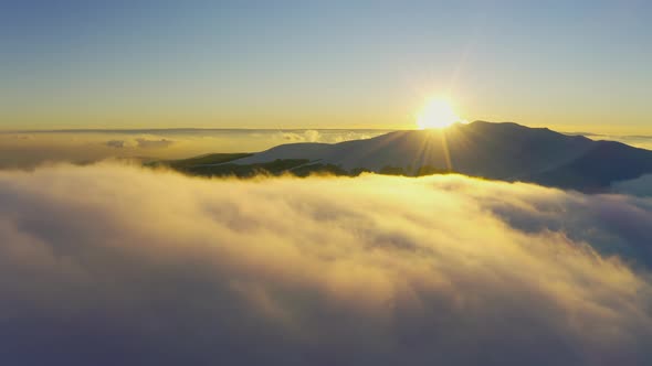 Wonderful View of Extraordinary Cloudy Valley and Bright Orange Sunset