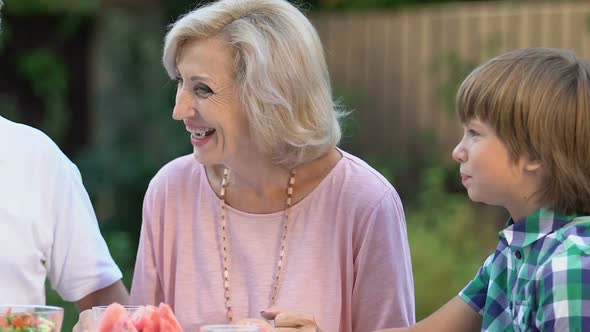 Happy Senior Couple Having Dinner With Grandchildren, Sweet Childhood Memories