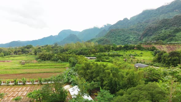 Aerial view of Northern Thailand farming community and jungle.