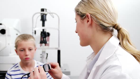 Female optometrist prescribing spectacles to young patient