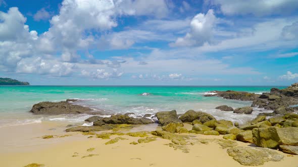 Seascape in sunny day white clouds beautiful blue sky rock and sand beach Phuket Thailand