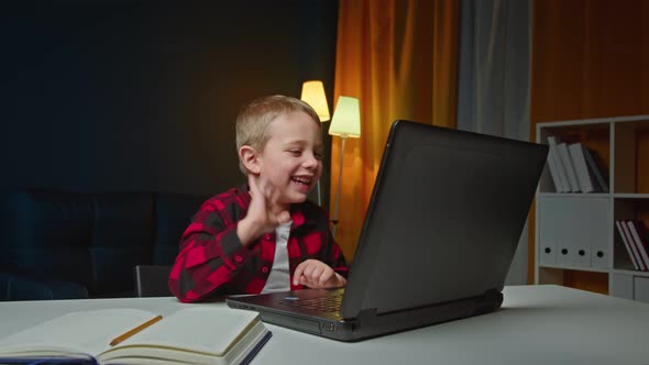 Cheerful Kid Using Laptop for Communication