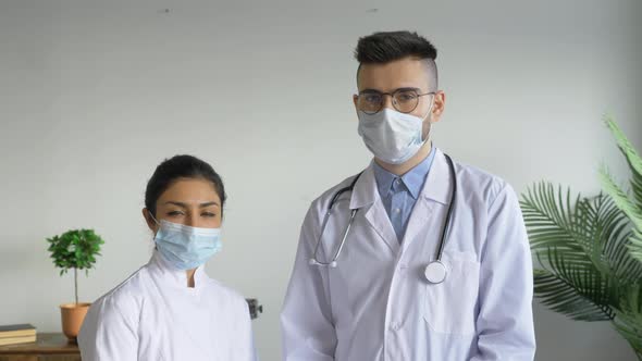 Portrait of a Young European Man, A Serious Doctor and a Young Indian Woman Looking at the Camera