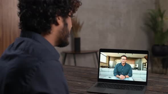 Closeup of Pakistani Man with Curly Hair Using App for Distance Video Communication