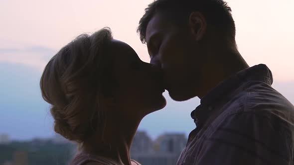 Young Couple Kissing on Sky Cityscape Background, Youth Love, Togetherness