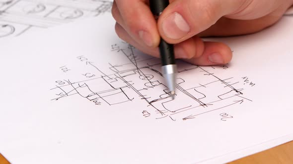 Person's Hand Drawing Plan On Blue Print. Close-up