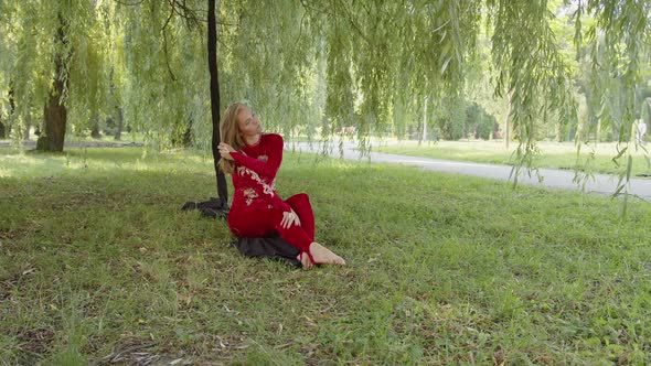 Girl Sits Beside Her Aerial Silk in the Park