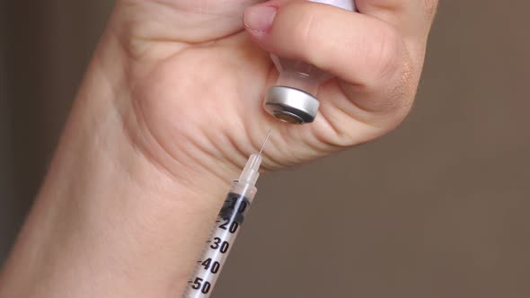 Girl Picking Up Insulin in a Syringe Closeup