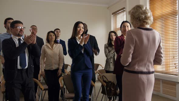 Cheerful Diverse Co-workers Team Greeting Speaker