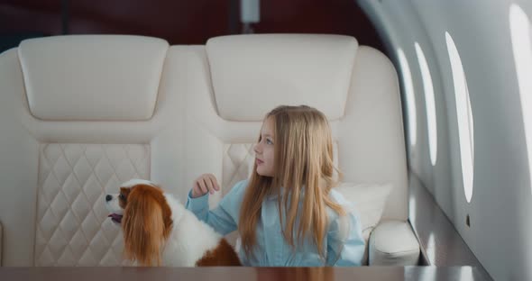 Stewardess Taking Order From Little Girl with Dog in First Class Cabin
