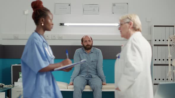 Young Patient Sitting in Medical Cabinet and Waiting for Exam Results