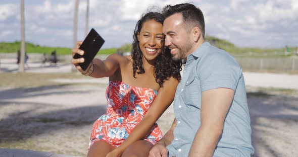 Excited Couple Taking Selfie on Seafront