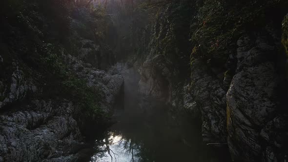 Flying Over a River Through a Narrow Canyon with White Rocks Sochi