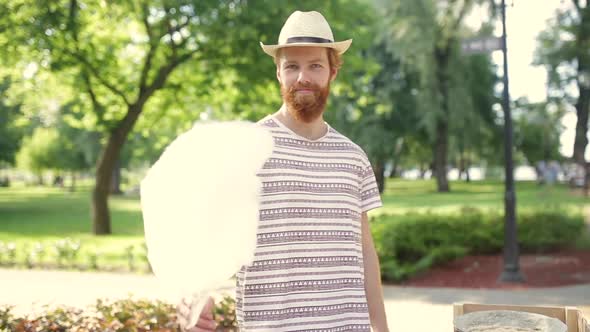 Video Theme Is a Small Business Cooking Sweets. A Young Caucasian Man with a Beard a Street Vendor