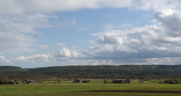 Rural Spring Village Landscape On A Background Of Pine Forest. Timelapse