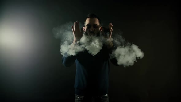 Bearded Man Vapes One Big Ring of Steam with Electronic Cigarette in Slow Motion