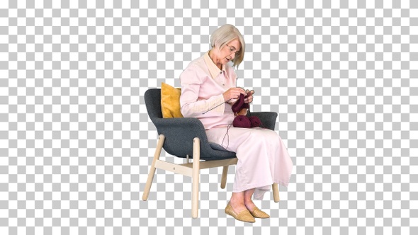 Elderly woman knitting sitting on a chair, Alpha Channel