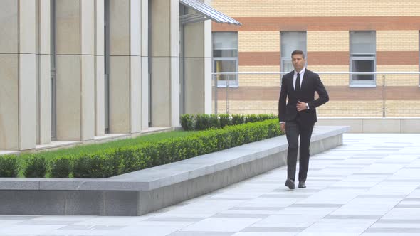 Attractive Businessman Goes Around the Building