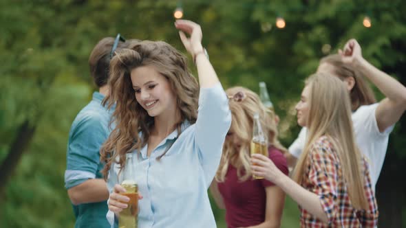 Beautiful Girl Dancing With Friends At Outdoor Party