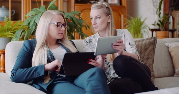 Businesswomen Discussing Over Technologies In Office