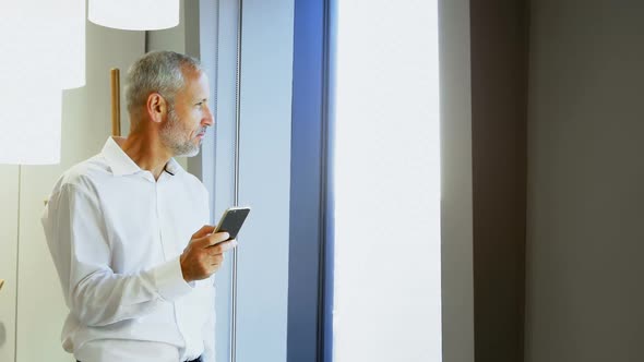 Businessman using mobile phone in hotel room 4k