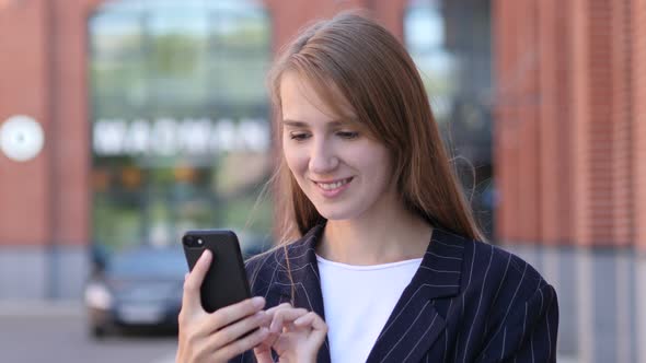 Portrait of Businesswoman Busy Using Smartphone