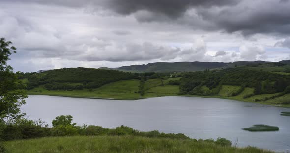 Time Lapse of nature landscape of hills and lake on a cloudy day in Ireland.