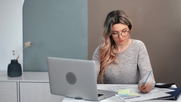 Focused Female in Glasses Studying e Learning Use Laptop Writing Notes