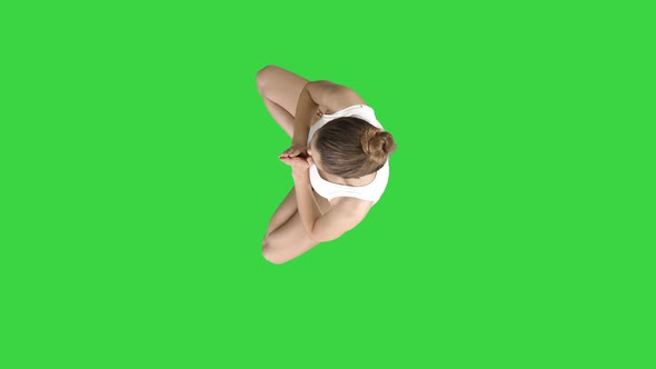 Young Caucasian Blonde Woman Practicing Yoga on a Green Screen, Chroma Key