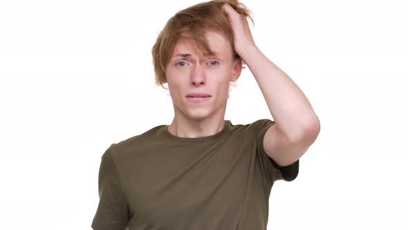 Horizontal Portrait of Tense Blond Man Grabbing His Head Being Stressed Thinking About Solution of
