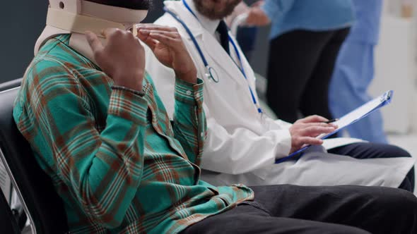 African American Patient with Medical Neck Collar Talking to Physician