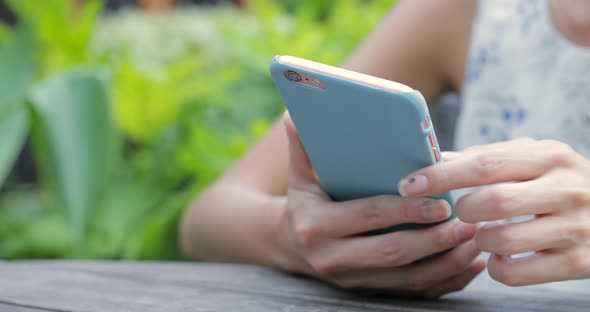 Hands Texting on Smartphone in Cafe