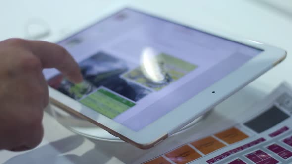 Young Man Uses A Modern Tablet In The Office