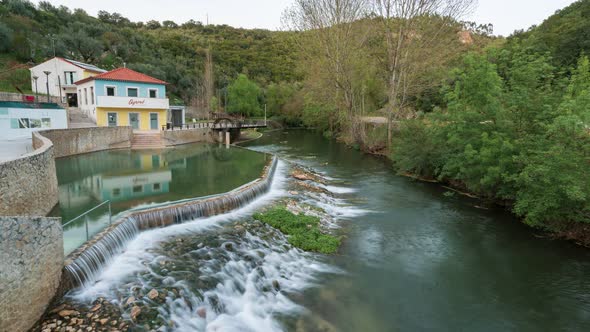 Timelapse of Fluvial River beach in Agroal with a waterfall and water mill in Portugal