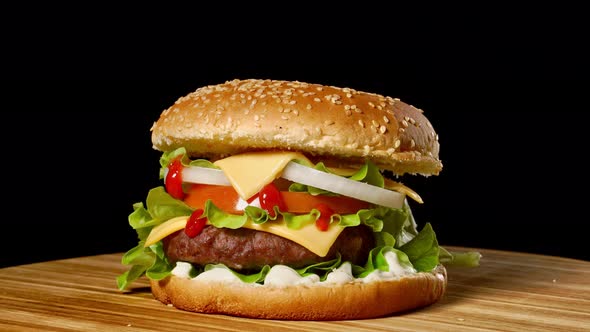 Cheeseburger with Bacon on a Dark Background. Close-up. Macro Shooting.